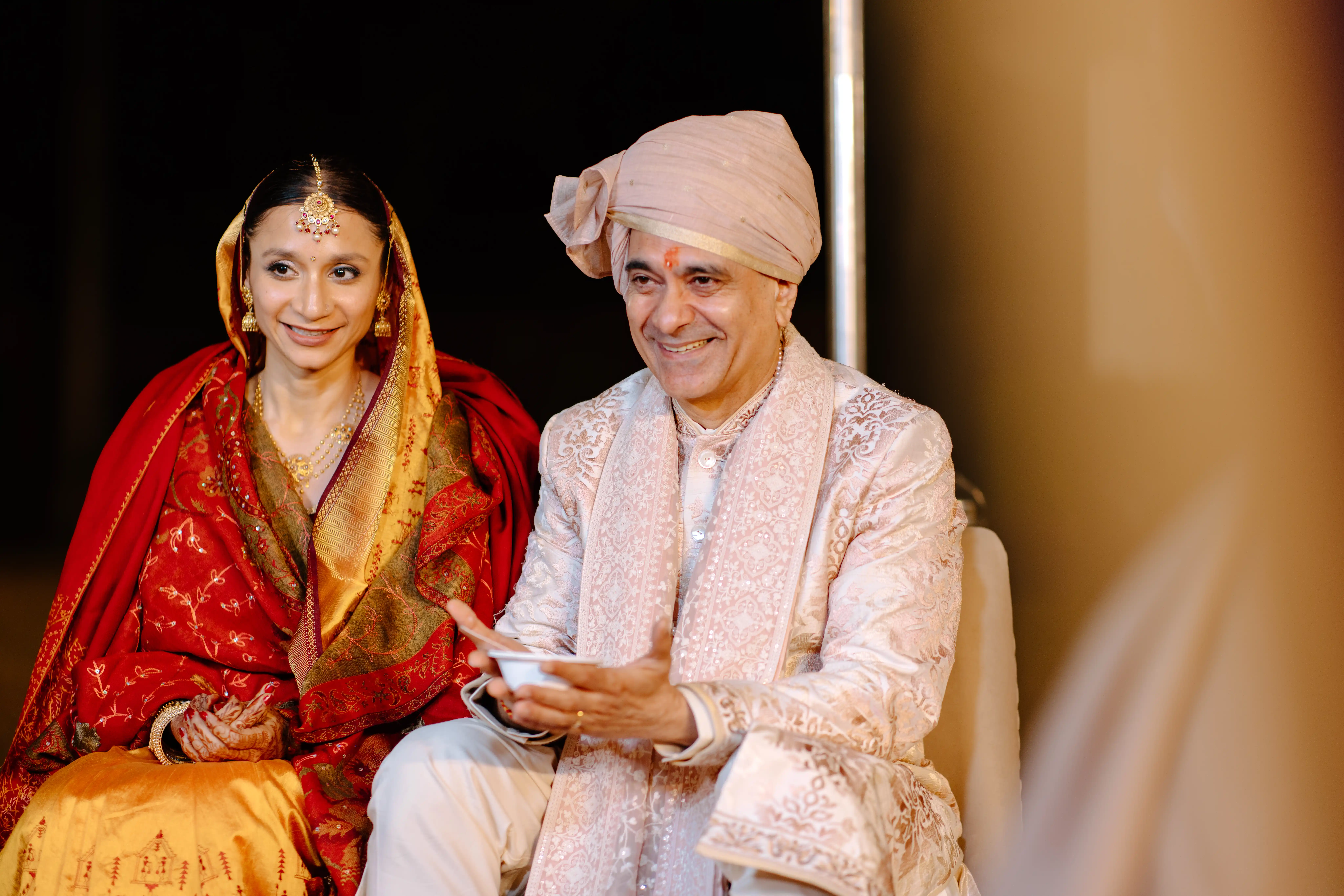 A happy newlywed couple embraces, beautifully captured, illustrating the result of choosing the right wedding photographer.