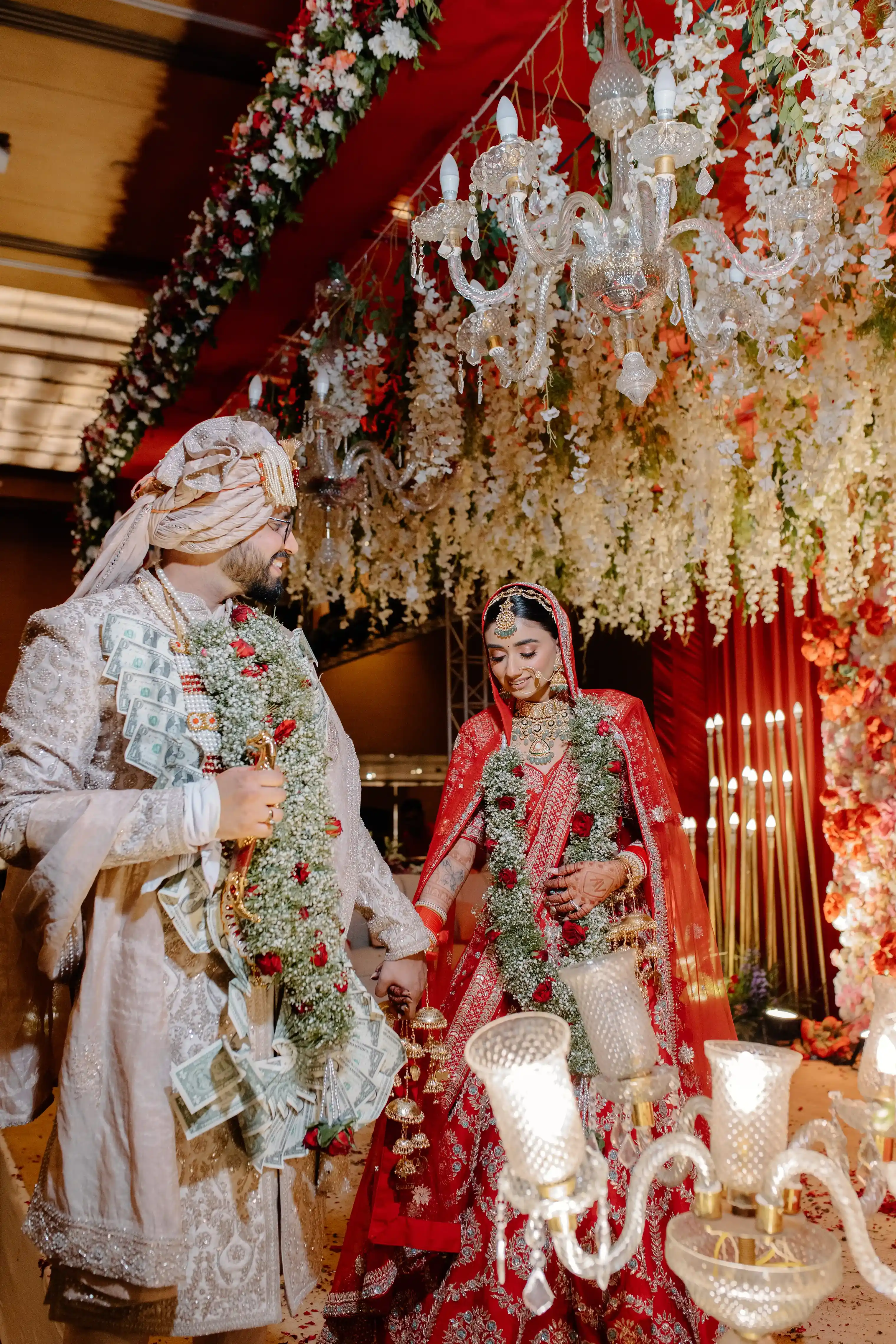 A grand wedding portrait of Vrinda and Anmol on their stunning floral stage at Le Méridien, New Delhi.